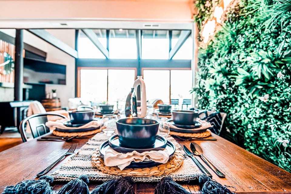 Dining table seats 6 comfortably and looks out at beautiful mountain views