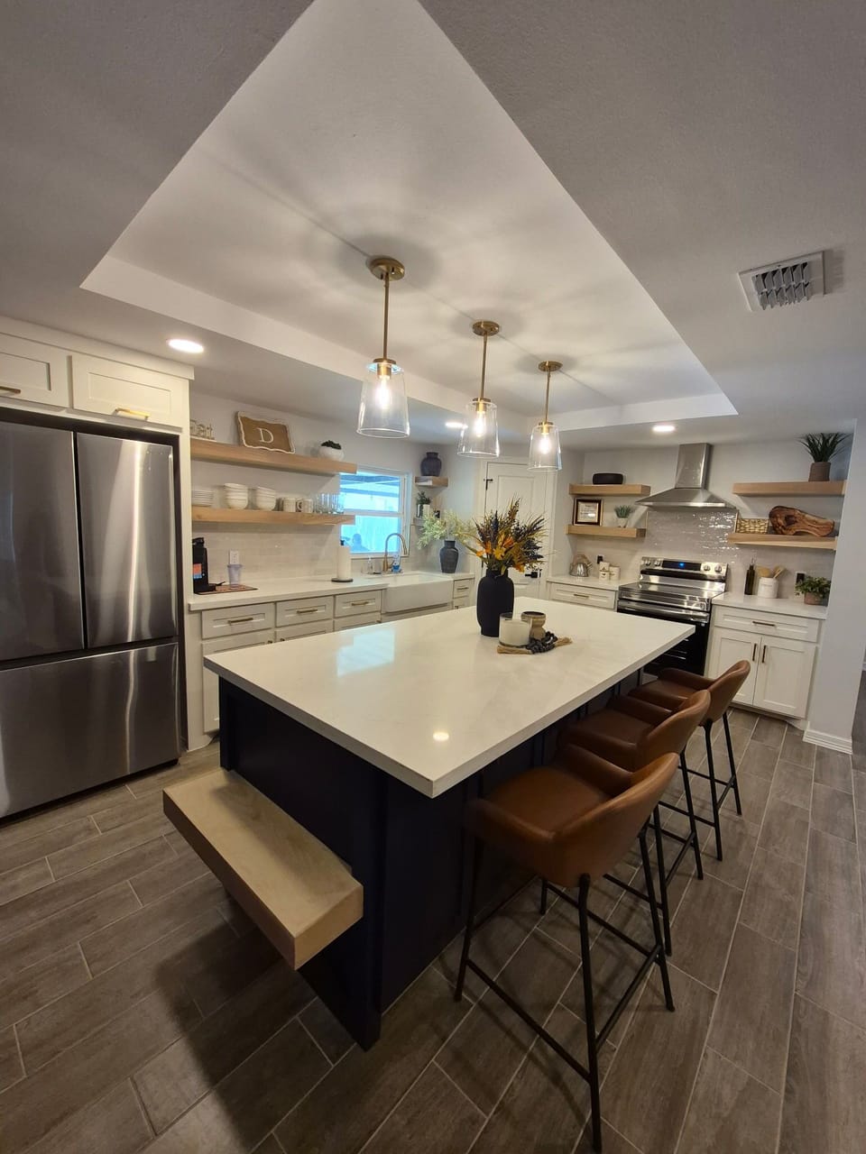 The fully equipped kitchen features an open concept with ample bar seating. 