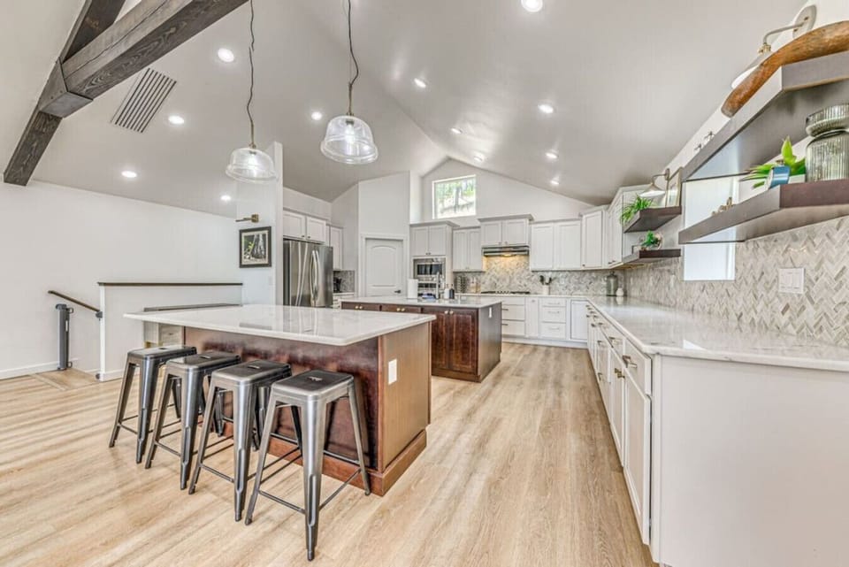 Kitchen | Expansive, modern design with a large island, pendant lighting, and sleek finishes
