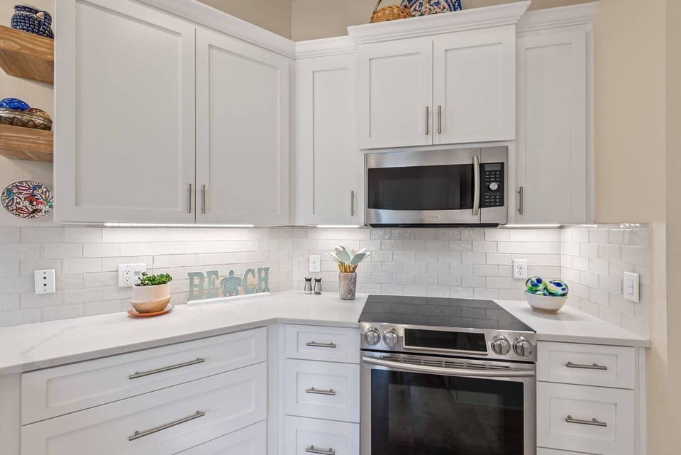 Kitchen with view of range, oven, and microwave