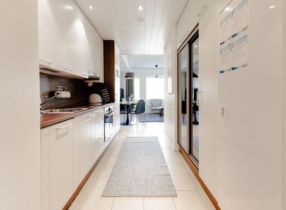 Bright, fully equipped kitchen with modern appliances and a practical layout right by the entrance.
