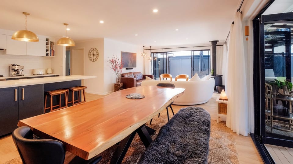 Sculpted timber table as dining centrepiece