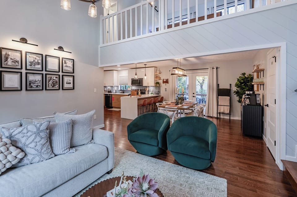 Cozy living space with sofa, fireplace, and tall ceilings.