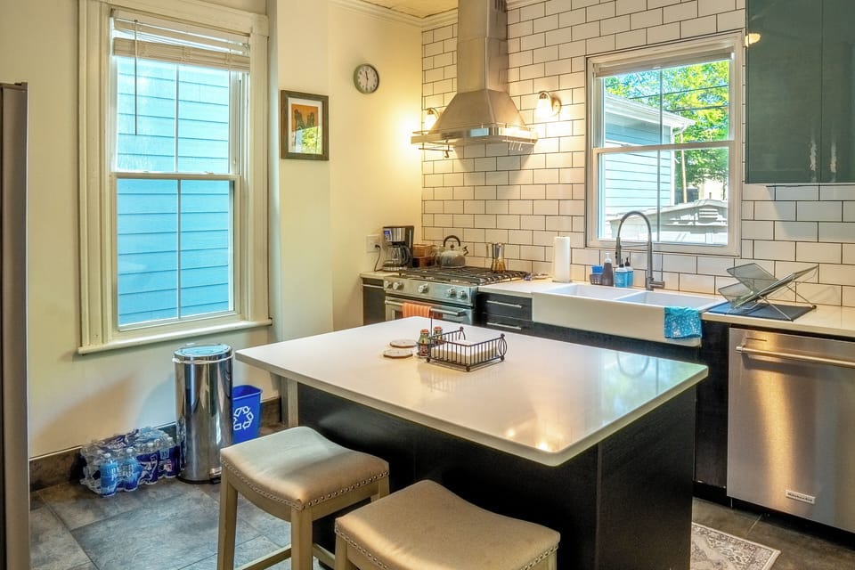 Stainless steel appliances and gas stove. Coffee pot, grounds, and tea kettle. 