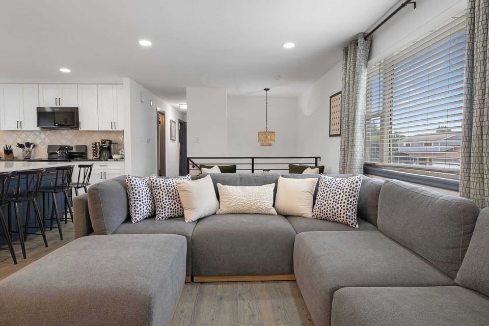 The upstairs living room has a comfortable sectional and an HD TV. 