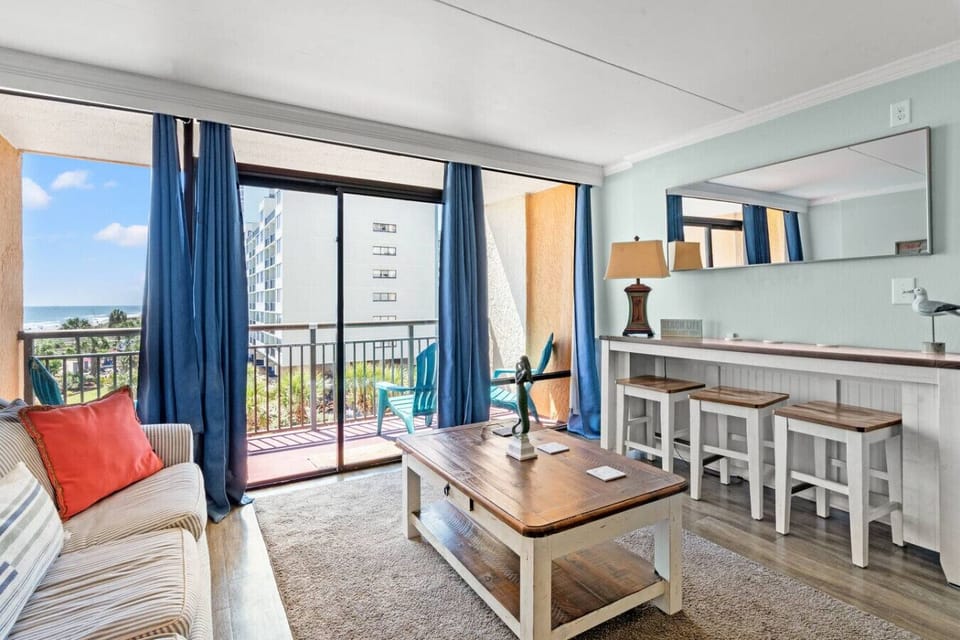 Livingroom with Oceanview and Floor to Ceiling windows allowing natural lighting for that beach-feel.