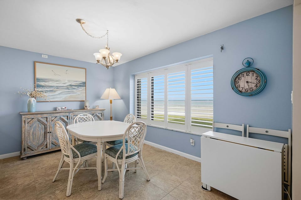 Enjoy meals with beautiful ocean views in this bright coastal dining area. Featuring comfortable seating, beach-inspired décor, and large windows overlooking the shoreline, it's the perfect spot to gather during your relaxing beach stay.
