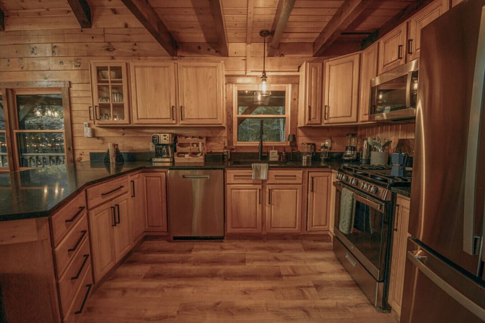 Spacious kitchen with stove and fridge