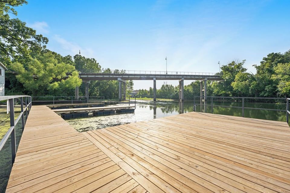 Enjoy a scenic stroll along the creek on this accessible bridge just steps from the property, connecting you to nature and relaxation.