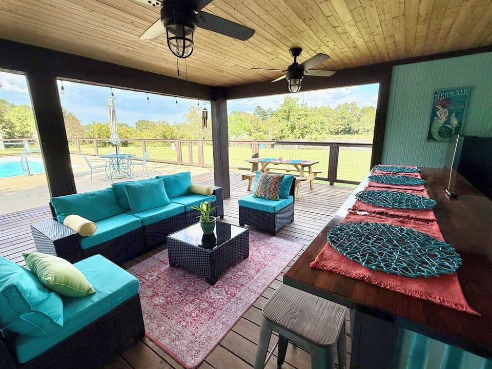 Poolside Gazebo overlooking the lake. High top bar, TV, fridge, and 1/2 BATHROOM
