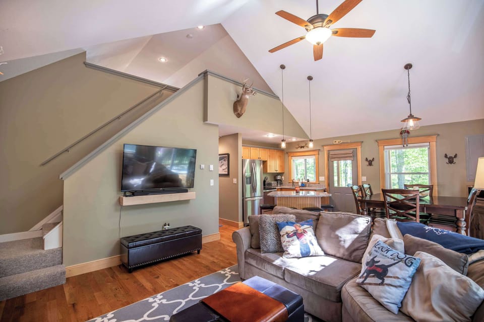 Large living room featuring a comfy couch, Smart TV, and gas fireplace