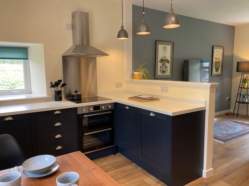 The kitchen area connects through to the to the living area in this open plan cottage