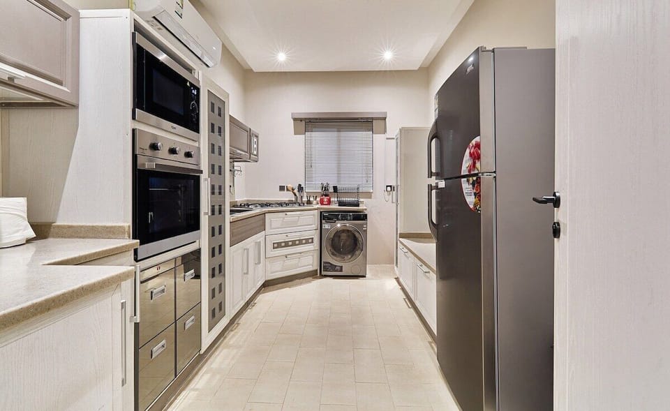Kitchen: "Prepare delicious meals with ease in our fully equipped kitchen, complete with modern appliances and ample space for culinary adventures."