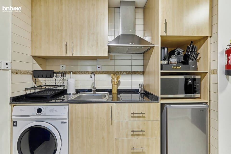 Sleek and contemporary kitchen space, complete with all essential amenities for home-cooked dining.