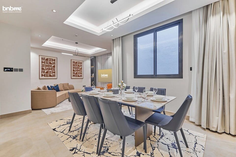 A stylish dining area with a table for eight, perfect for enjoying family meals or hosting friends.