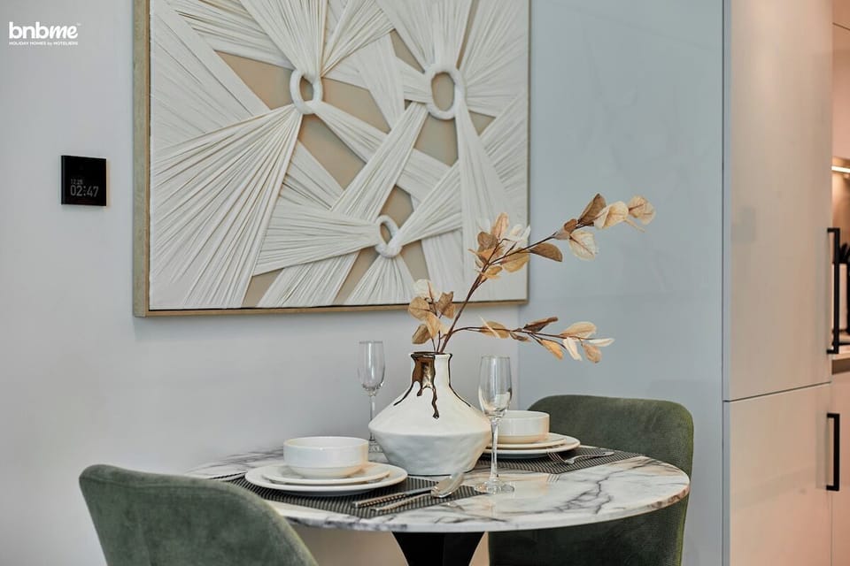 A stylish and minimalist dining space for two, ideal for enjoying breakfast or dinner, featuring a modern table and comfortable chairs.