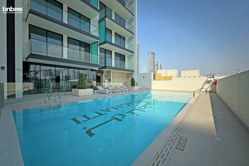 Enjoy a tranquil escape at the poolside, with crystal-clear water surrounded by lounge chairs and shaded areas, offering a peaceful retreat from the hustle of the city.