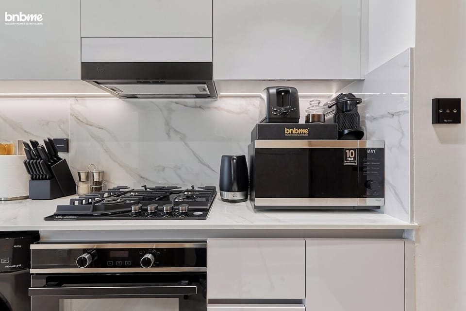 Cook and dine with ease in this stylish kitchen, featuring all essential appliances.
