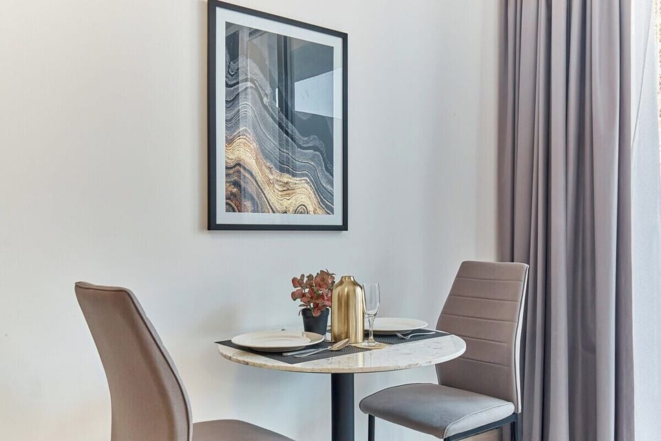 Savour delicious home-cooked meals at this elegant and well-lit dining setup.