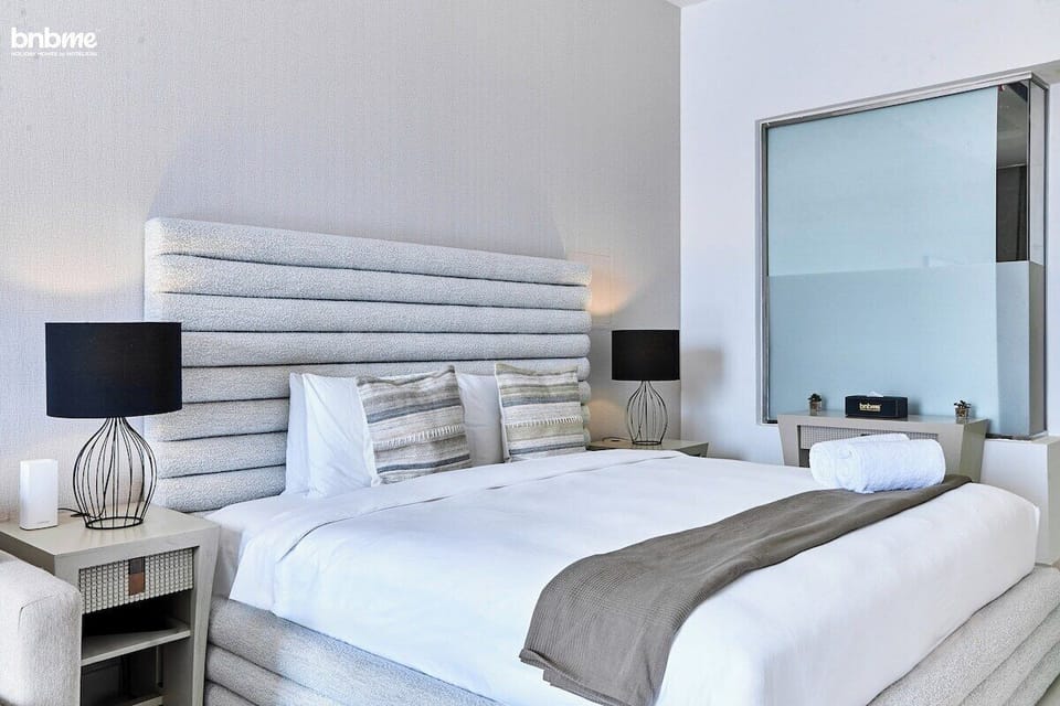 Unwind in the welcoming bedroom, featuring a luxurious king bed, a comfortable sofa for relaxation, and a TV to enjoy after a long day.