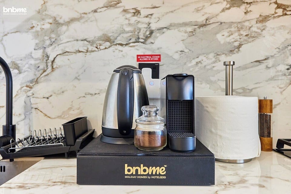 Sleek and fully equipped, this modern kitchen features high-end appliances, a stylish marble backsplash, and ample storage. Whether you're brewing your morning coffee or preparing a home-cooked meal, everything you need is right at your fingertips.