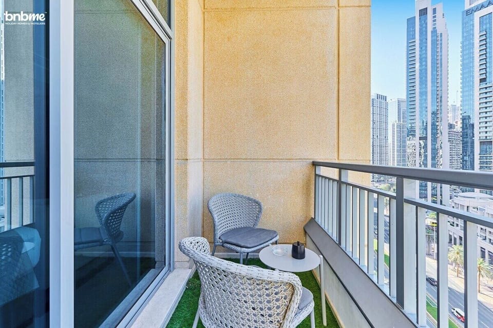 Step out to a private balcony with cozy seating—perfect for morning coffee or sunset views over Downtown Dubai.