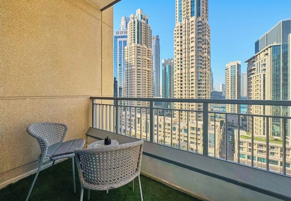 Step out to a private balcony with cozy seating—perfect for morning coffee or sunset views over Downtown Dubai.