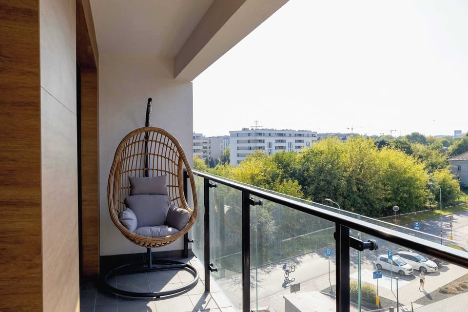 The balcony's stylish design complements the apartment's decor.