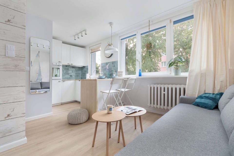 The living space with a comfortable sofa and large window combines functionality with modern design.
