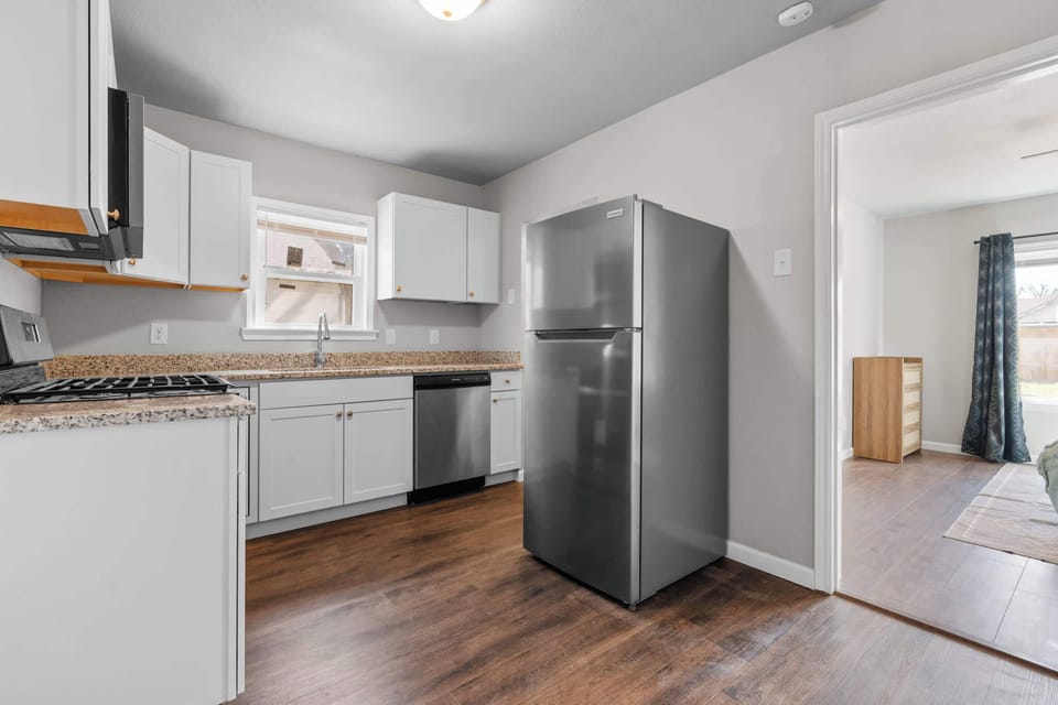 This kitchen offers an open, airy layout that allows for natural light to flood the space. Expansive countertops, custom cabinetry, and a large island create a functional yet stylish area, ideal for cooking, entertaining.