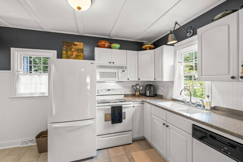 Great kitchen stocked with supplies/utensils and access to back porch/yard.