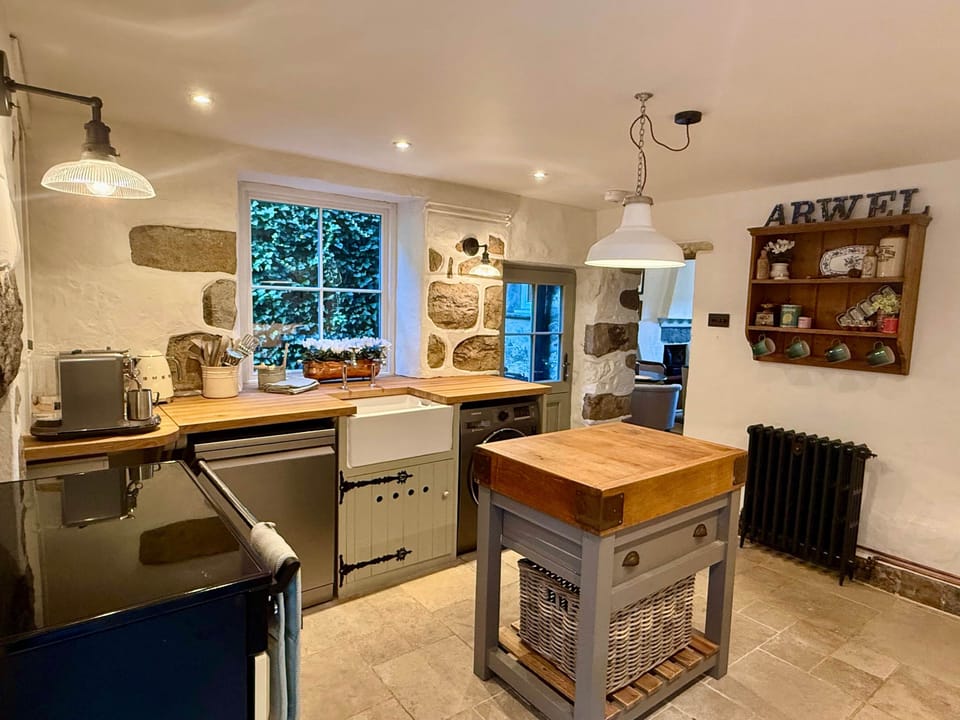 Traditional kitchen with modern appliances in Arwel Cottage