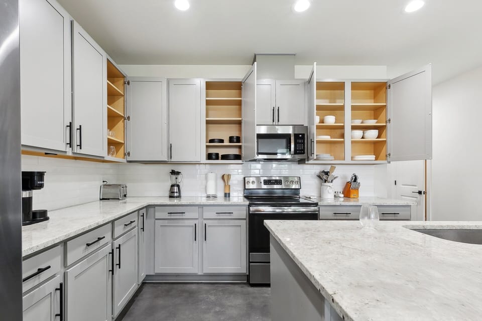 Fully stocked kitchen with cookware, dinnerware, and appliances including Keurig, electric kettle, rice cooker, and Instant Pot — everything you need to cook at home. o cook at home.
