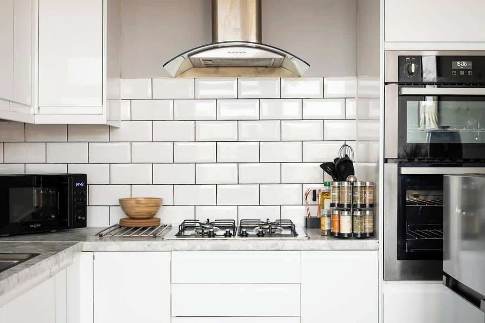 Kitchen: Whip up culinary delights in this sleek, modern space with stylish appliances!
