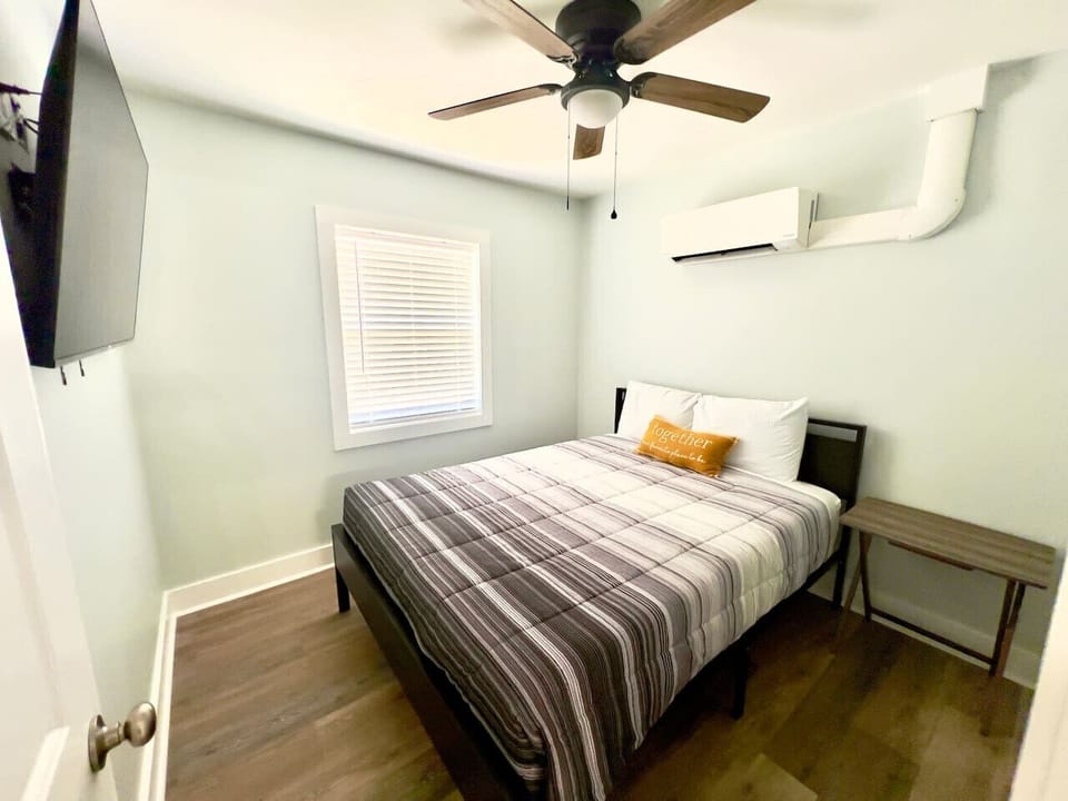 Queen size memory foam bed with tv and linen closet.