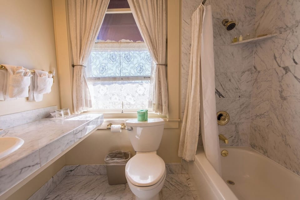 Refresh after adventures in a bright, marble-trimmed bath.