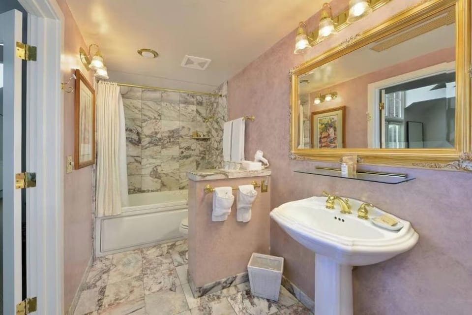Refresh in a marble-accent bath with warm, vintage elegance.