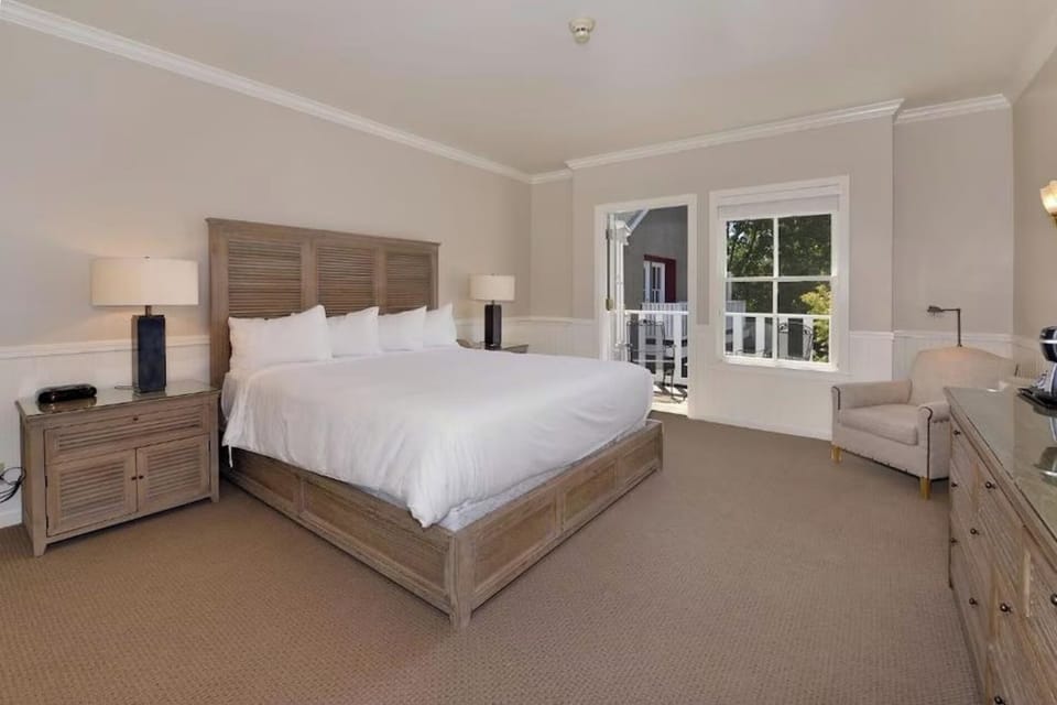 Settle into a king bed with cozy chair-side reading.