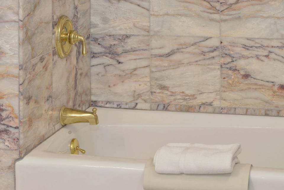 Soak away the day in a deep tub and marble surround.