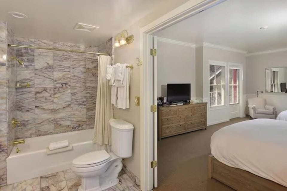 Refresh in a marble bath with plush robes and bright lighting.