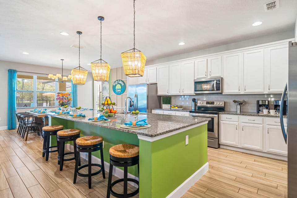 Fully equipped kitchen w/ modern appliances, ample counter space & breakfast bar