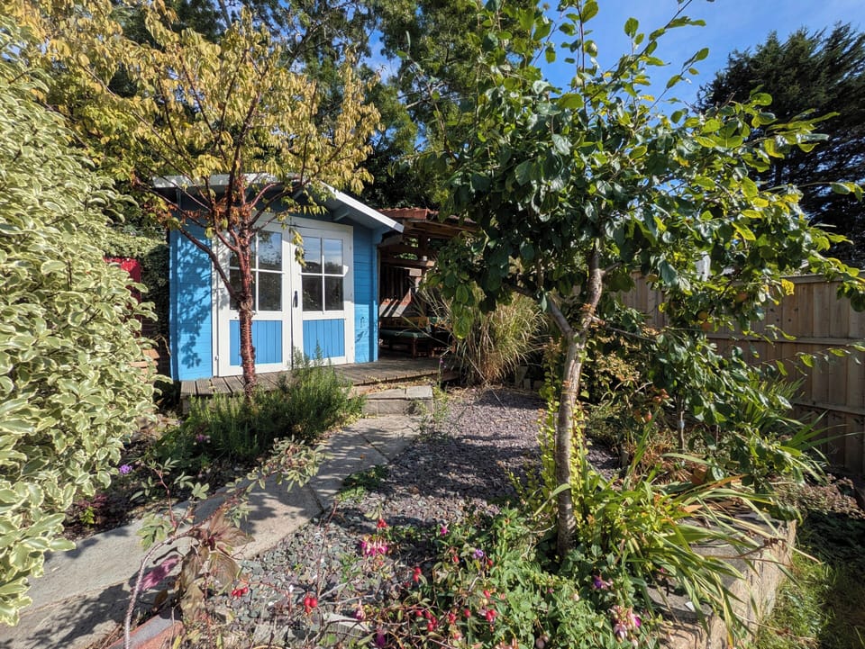 Well maintained, large back garden with cabin and 3 different seating areas, one covered. There is also a BBQ area. Cabin has amplifier and speakers that can be connected to a mobile phone or other device. 