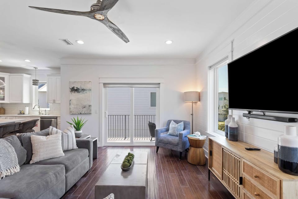 Living room [main floor]: Sectional seating, smart TV, patio access