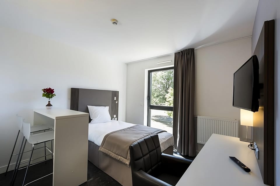 Relax after exploring with a comfy chair and in-room TV.