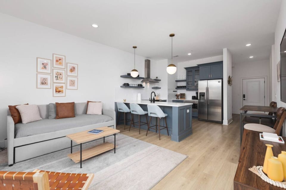 Condo 1 - Open floor plan with lots of natural light, Smart TV, and seating at the kitchen counter. There is also a separate high-top dining table with seating for 4.