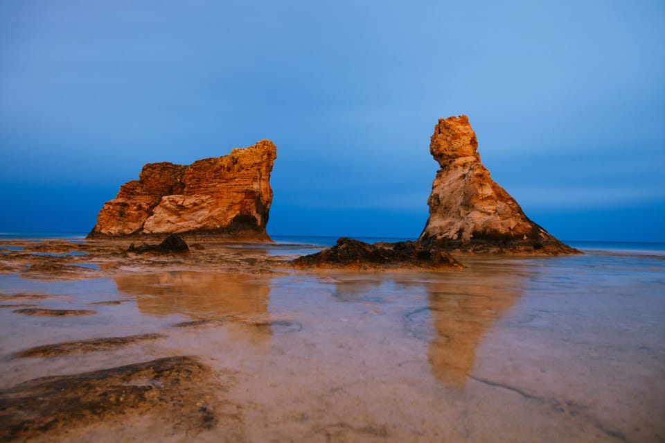 Escape to golden sea stacks and calming sunset tides.