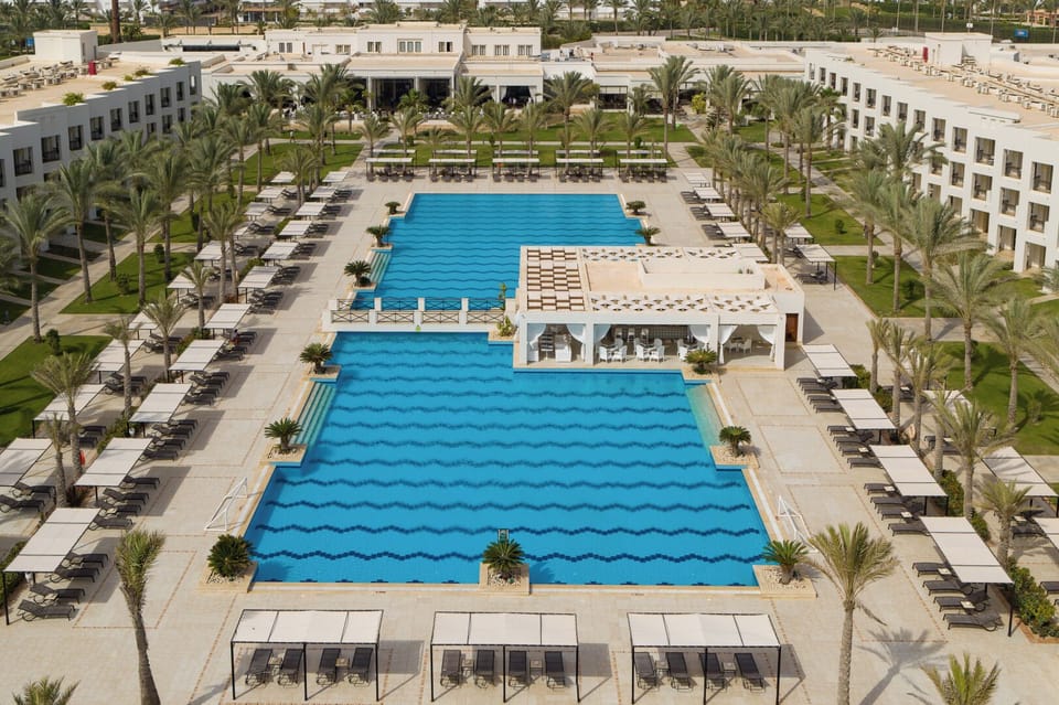 Admire the resort’s grand layout with twin turquoise pools.