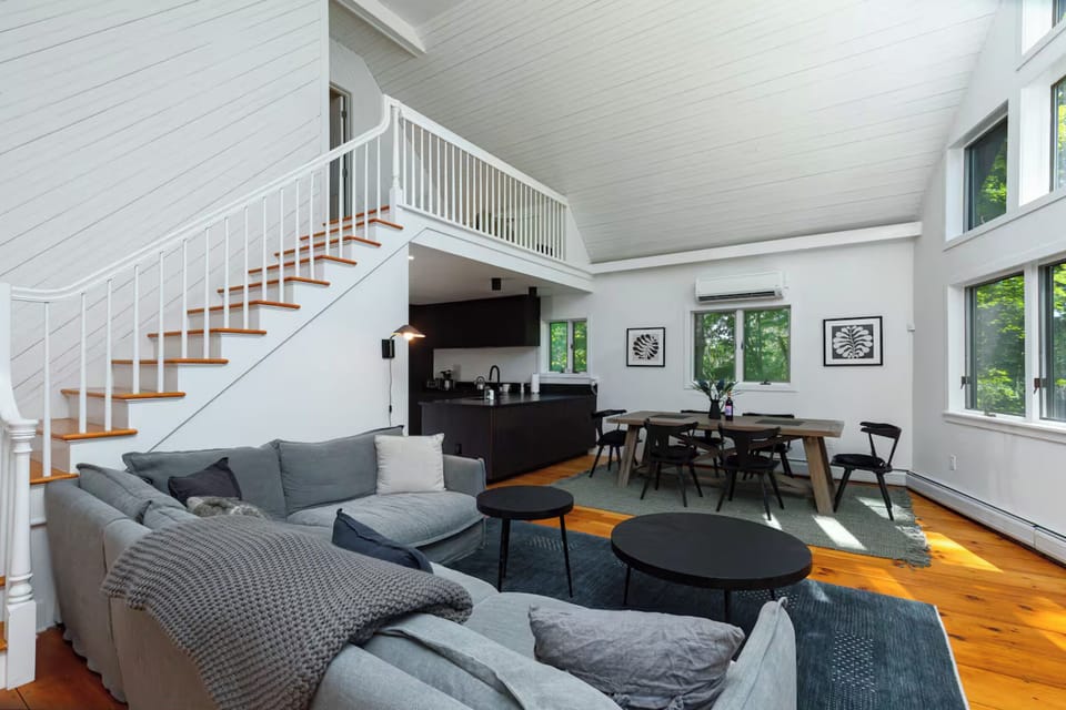 View of the kitchen, dining, and living area. Stairs lead to upstairs master bedroom