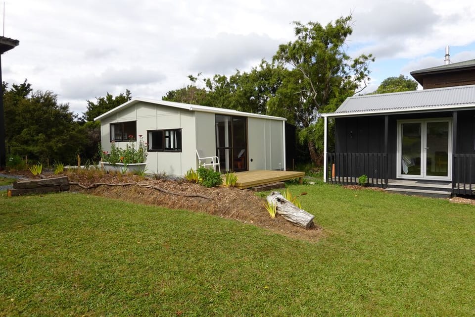Living Shed and Queen Cottage from lawn