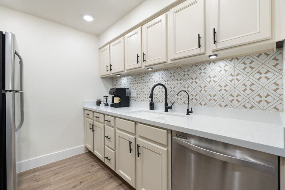 Modern kitchen with cookware, utensils & dining area